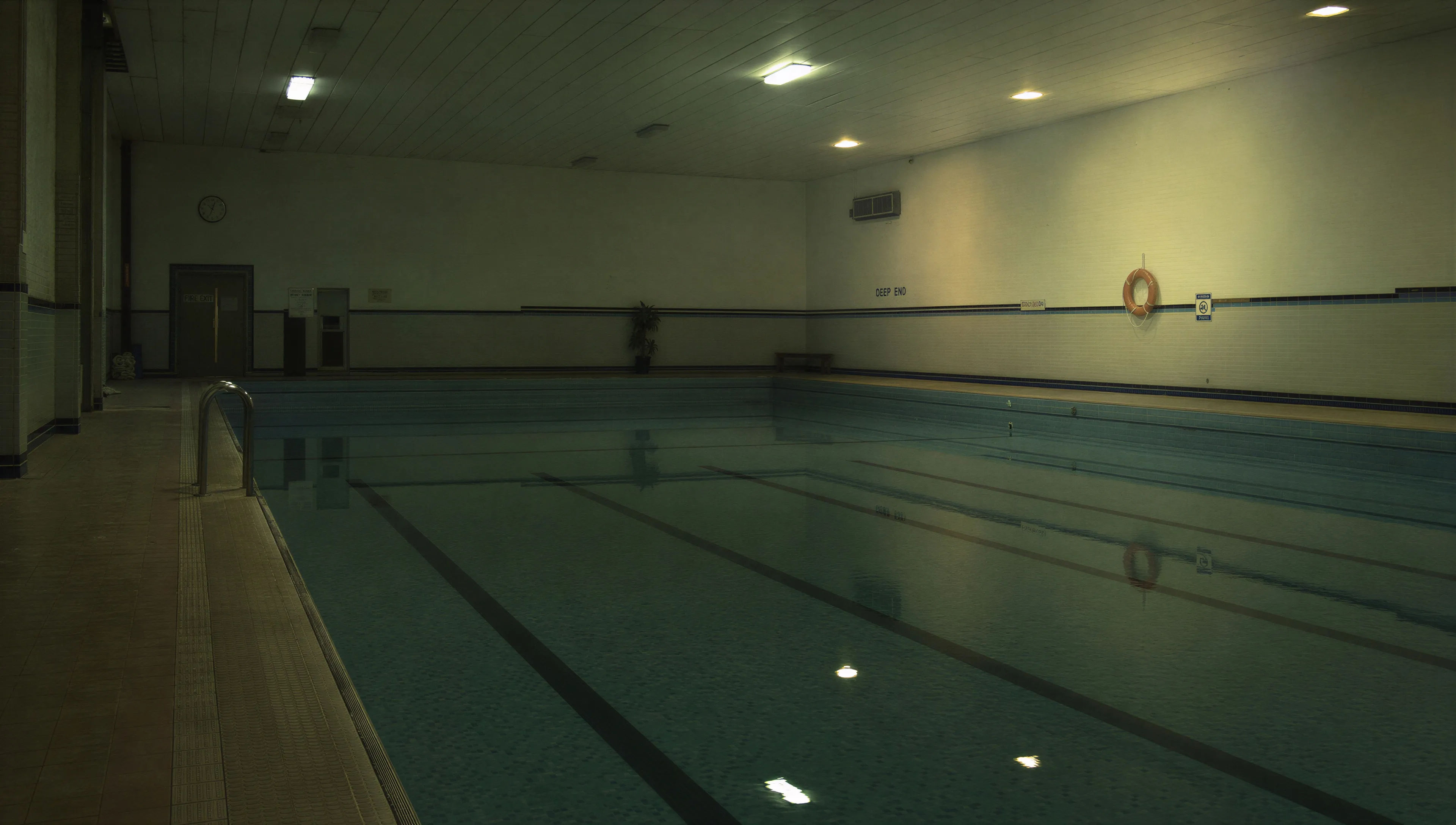 Indoor swimming pool, lights on, empty